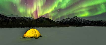 Glowing yellow tent set up under Aurora Borealis 2014 03 20 Alaska Wiseman NorthernLights 22 53