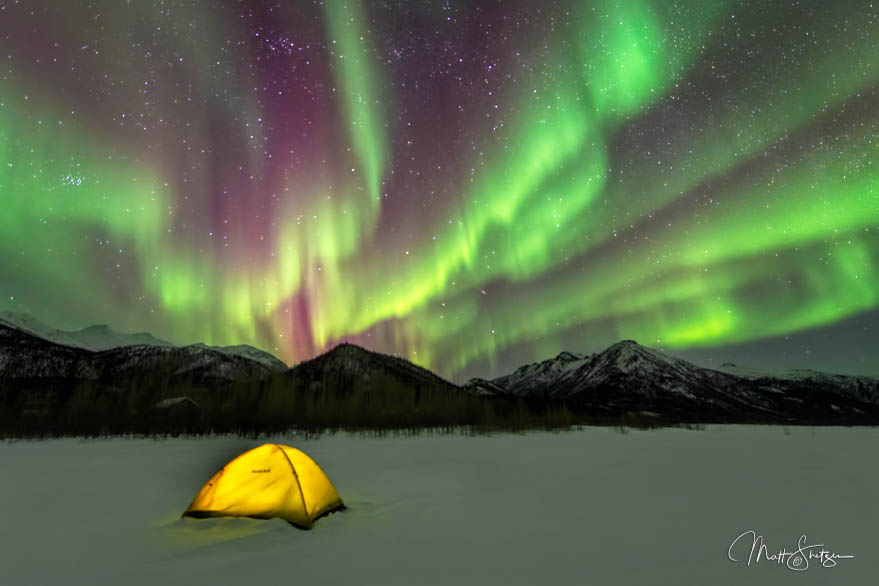 Glowing Yellow Tent Set Up Under Aurora Borealis