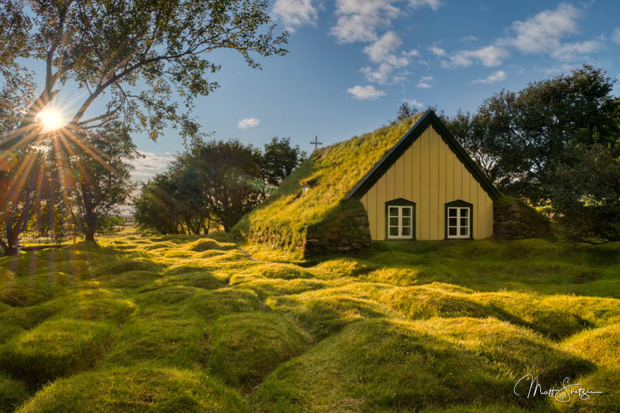 Sunset Over Turf Roofed Church In Iceland