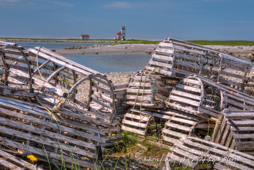 Empty lobster pots with a lighthouse in the background