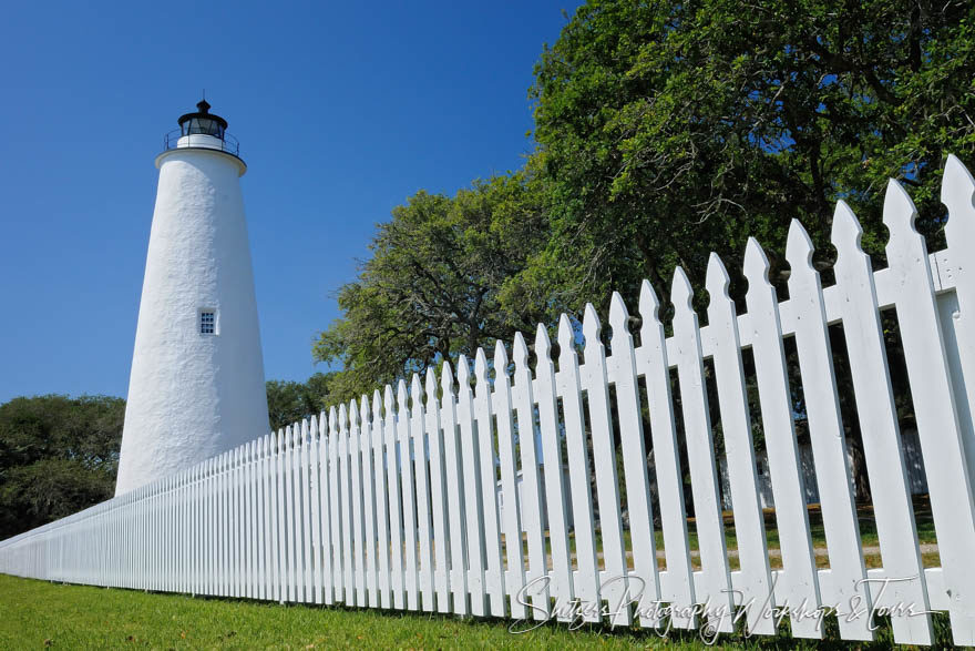 White picket fence with Ocracoke lighthouse