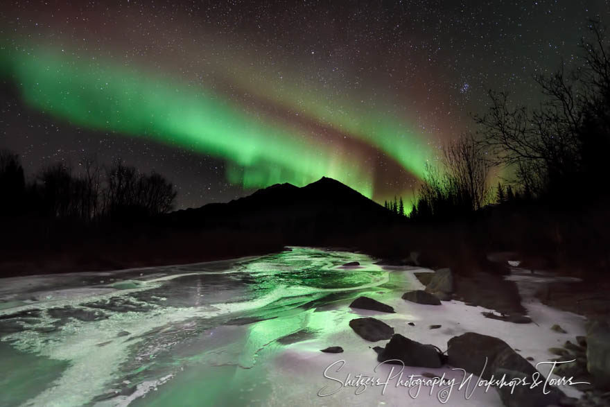 The green glow of the Aurora Borealis